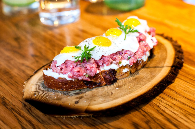 Steak Tartar On Bread Placed on Wooden Plate