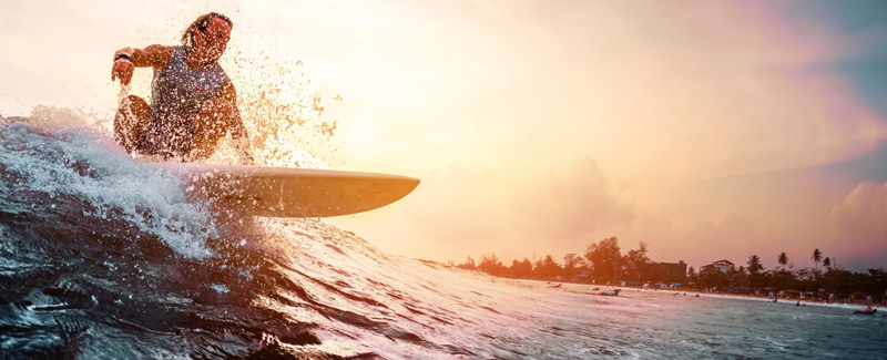 Surfer Riding Wave At Sunset at Wind And Sea Beach In San Diego California 