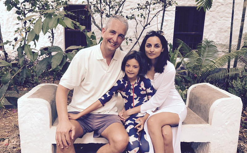 Farzana Baduel Sitting On Park Bench With Husband Marco Baduel And Daughter Isabella Baduel