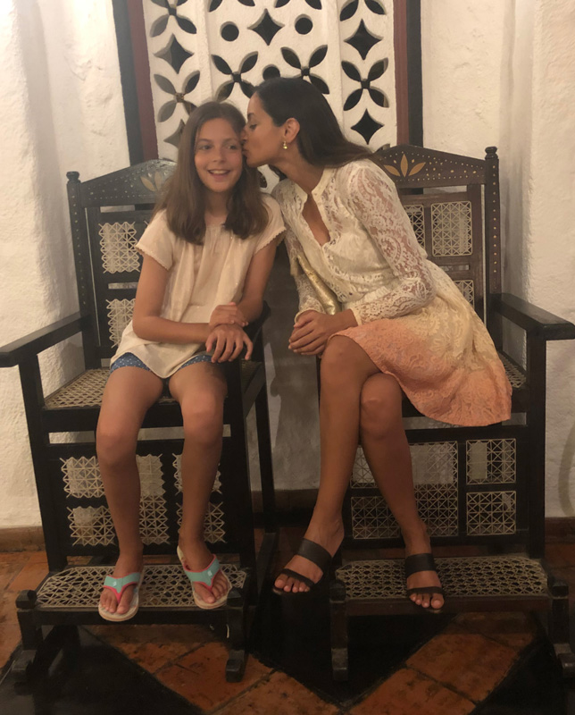 Farzana Baduel Kissing Daughter on Cheek While Sitting On 2 Big Chairs