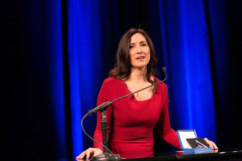 Irem Tuzunalper In Red Dress Accepting An Award And Giving Speech At Podium