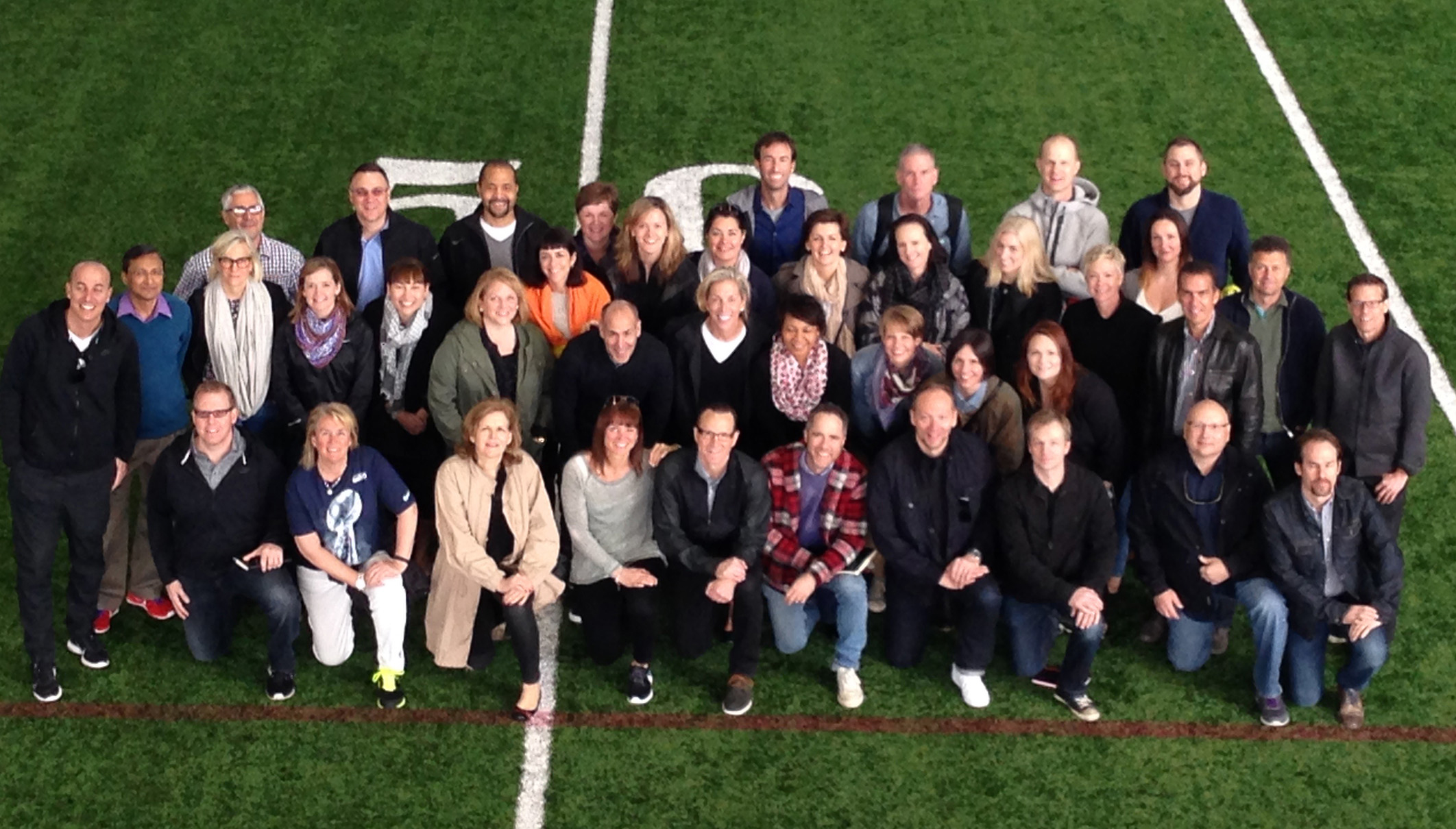 Overhead Photo Of Jan Singer And Her Team At Nike On NFL Turf