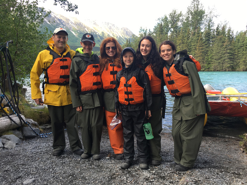 Kara Goldin And Family With Life Vests Standing By River Side