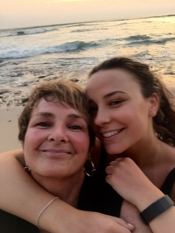 Pam Klein And Daughter Hugging Each Other On Beach In Costa Rica With Sea In Background
