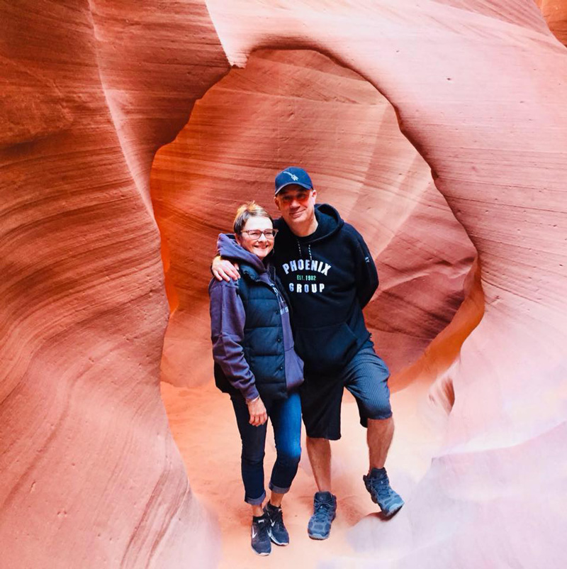 Pam Klein With Husband Stephen Holding Each Other For Photo in Arizona Rock National Park 