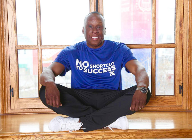 Bruny Surin Sitting With T-Shirt Slogan No Shortcut To Success
