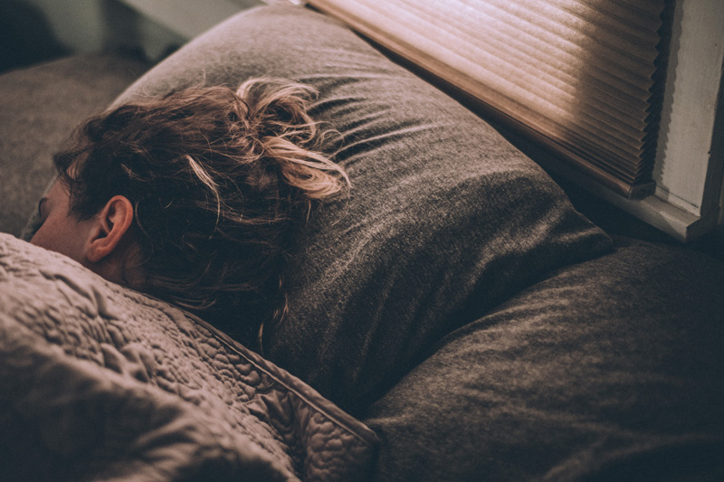 Woman Sleeping With Head On Pillow