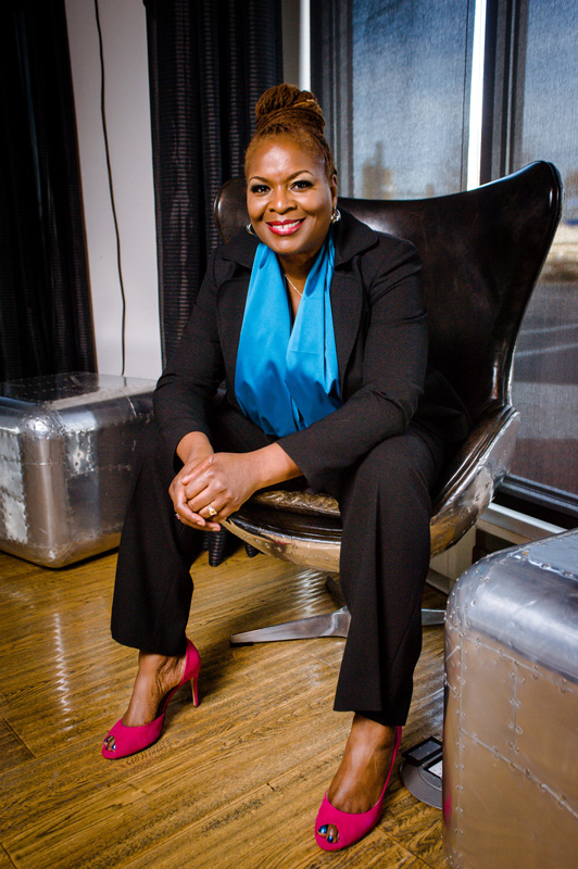 Smiling African American Women In Business Suit Sitting Confidently In Chair