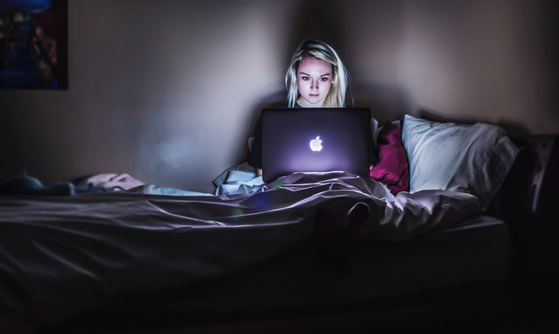 Woman On Laptop In Bed At Night